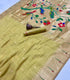 Soft Muga Cotton A light olive green saree with a beige and gold zari border, decorated with colorful hand-painted birds and flowers on the pallu