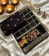 Viscose Georgette rich black and gold zari-embroidered grid pattern.