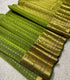 SIco Gadwal green body with small gold zari motifs and a broad gold zari brocade border